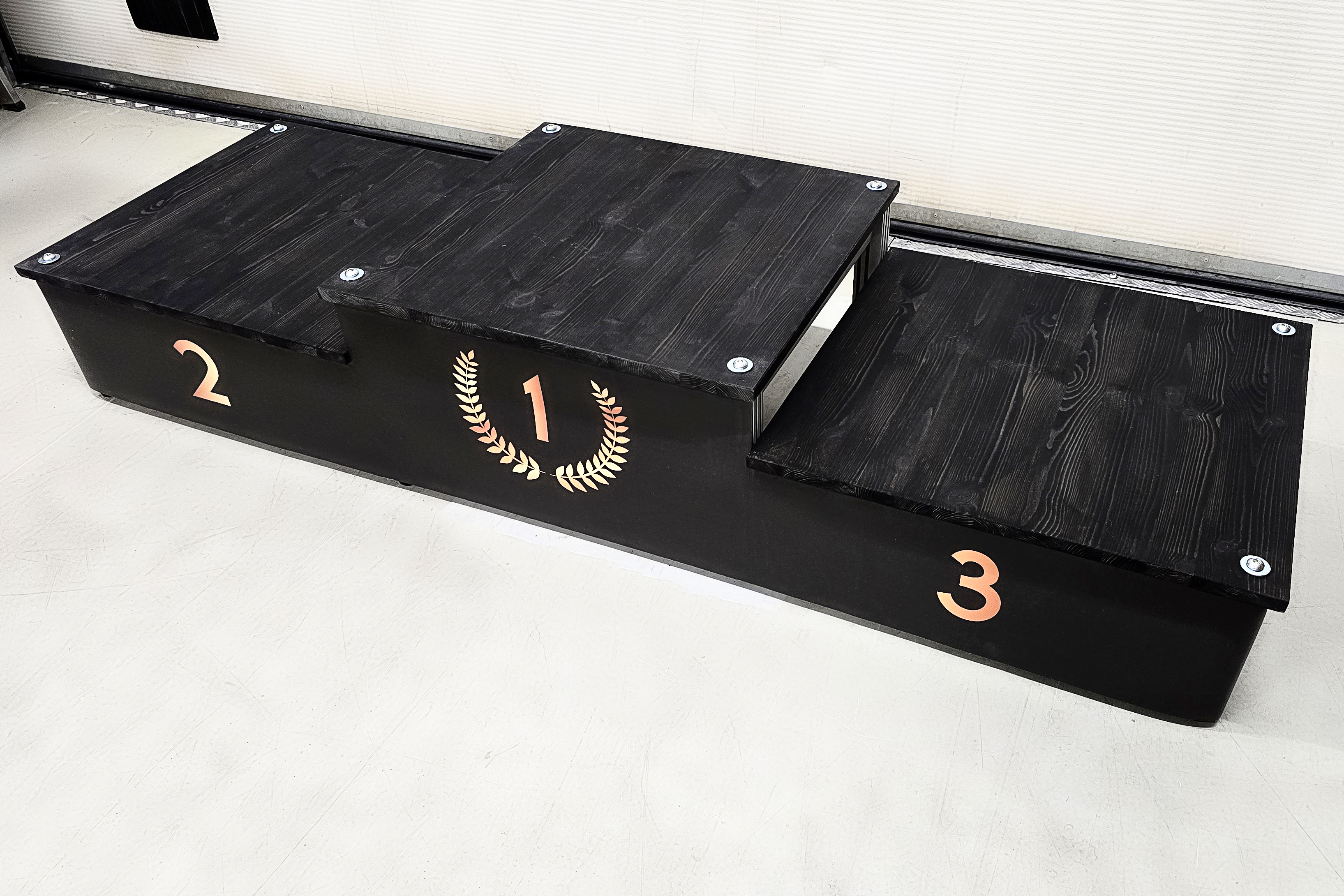 Siirrettävä palkintokoroke jossa on vaihdettava grafiikka.